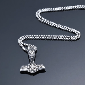 Detailed close-up of retro Viking Thor's Hammer pendant with skull engraving in silver finish