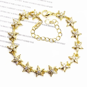 Detailed view of adjustable gold star bracelet with micro-paved cubic zirconia and lobster clasp