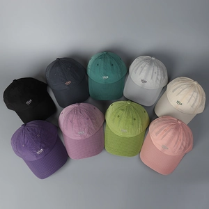 Flat lay of colorful plaid baseball caps with Nice embroidery in nine various colors