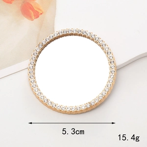 Detailed view of a 5.3cm gold makeup mirror charm with white rhinestones for DIY cases