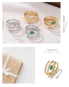 Detailed view of wrap-around snake rings with pear-cut emerald and white crystals