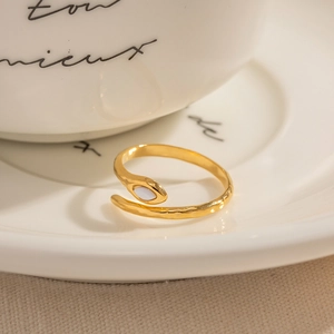 18K gold plated stainless steel snake ring with marquise stone on a ceramic plate