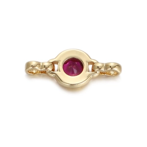 Detail of a golden heart jewelry connector with a pink faceted gemstone center