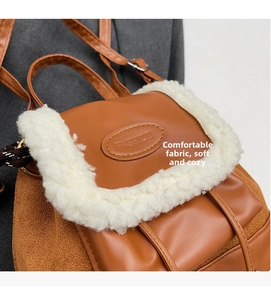 Detail of vintage brown leather backpack featuring white faux shearling trim and strap