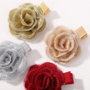 Close-up of four-piece woven camellia hair clips in gold, champagne, silver, and red