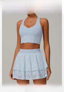 Close-up of light blue lace detailing on V-neck sports top and matching layered skirt