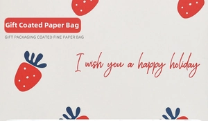 Macro detail of paper gift bag with red strawberry pattern and holiday greeting text