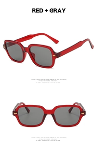 Detail of square red translucent sunglasses frame with silver rice nail rivet accents