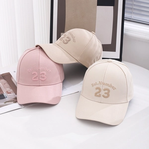 Classic baseball caps in pink, khaki, and cream colors with Est. Number 23 embroidery