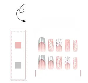 Detail of pink gradient press-on nails with silver French tips and 3D white bow charms