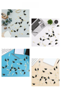 Miniature graduation cap and scroll confetti scattered across a party table setup