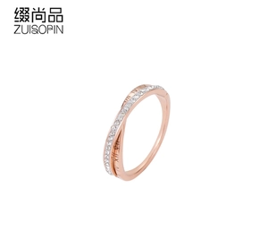 Detail view of rose gold crisscross ring with Roman numerals and micro-set cubic zirconia