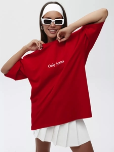 Close-up of Only Jesus white letter print on a heavy cotton red oversized t-shirt