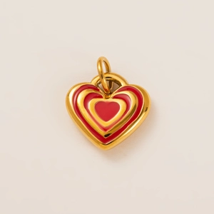 Macro shot of 18k gold plated heart pendant with layered red enamel details