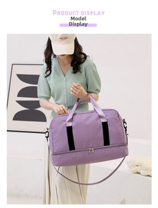 Detail of large purple travel bag with dry-wet separation held by a model in casual wear.