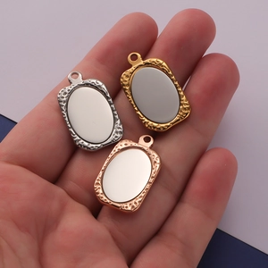 Three geometric stainless steel pendants in silver, gold, and rose gold with hammered borders