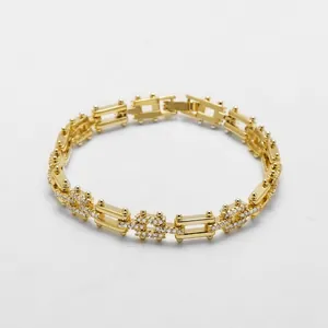 Detailed close-up of 18k gold plated bracelet with pave-set white zircon link patterns