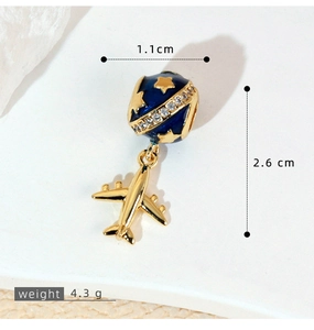 Macro shot of globe and airplane pendant with dimensions 1.1x2.6cm and weight 4.3g