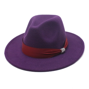 Close-up of purple wool fedora with a red satin band and silver rhinestone buckle detail