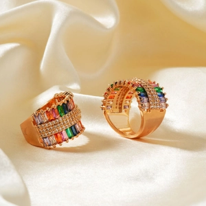 18K gold ring with multi-color rectangular zircon stones on cream silk fabric