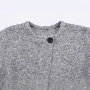 Grey knit cardigan with round neck and single black button closure on white background