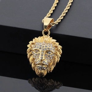 Gold plated lion head pendant necklace with rhinestones on a mirror surface