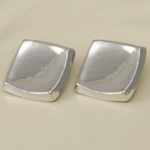 Detail view of silver square stud earrings with convex design in polished 304 stainless steel