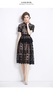 Detail of black hollow-out lace midi dress with waist belt and floral embroidery