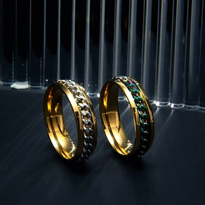 Macro detail of 6mm wide gold stainless steel rings with rotatable chain inlay accents