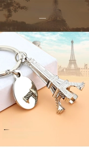 Silver Eiffel Tower keychain featuring a polished oval metal tag and zinc alloy charm