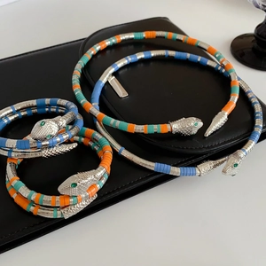 Detail shot of multi-layer snake jewelry set including colorful necklaces and bracelets