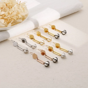 Minimalist pearl drop earrings in gold, silver and rose gold finishes on fabric