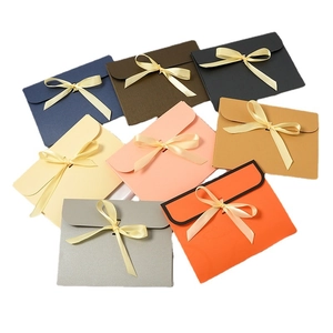 Elegant envelope-style gift boxes for scarves featuring colorful ribbon bow closures