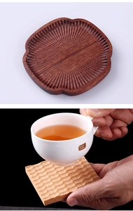 Detailed view of hand-carved lotus root wooden coasters with radial and wave patterns