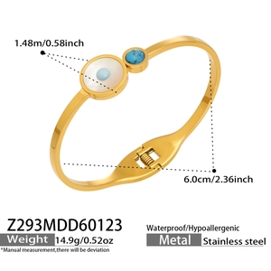Détails du bracelet à ressort en acier doré avec dimensions et breloque œil de protection