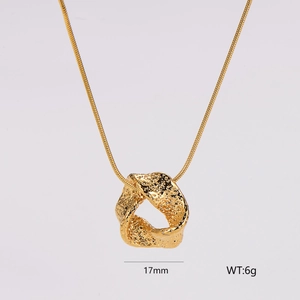 Detailed shot of golden necklace with 17mm twisted hammered texture pendant