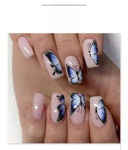 Close-up of pink glitter press-on nails featuring blue and white butterfly designs