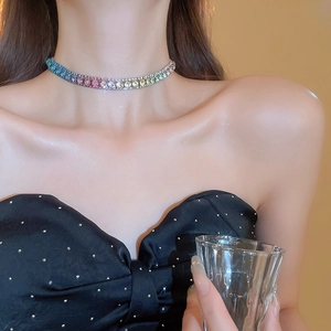 Close-up of rainbow gradient rhinestone choker necklace on model's neck with elegant shine