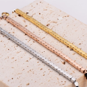 Three minimalist square bead stainless steel bracelets in gold, silver, and rose gold finishes