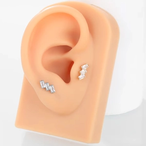 Detail of G23 titanium labret stud with rectangular zircon on a silicone ear model