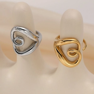 Adjustable hollow twisted heart rings in gold and silver set on a model stand