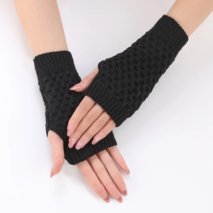 Detail of black pineapple knit pattern on winter fingerless gloves and arm warmers