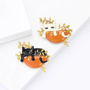 Cute lazy alloy enamel cat brooches in black and white with golden leaf accents