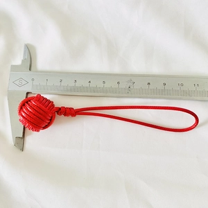 Handmade red monkey fist knot keychain with woven loop, 2.5cm diameter measurement