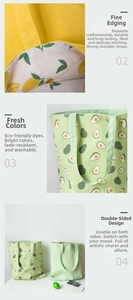 Detail of double-sided canvas tote bag with lemon and avocado patterns and reinforced stitching