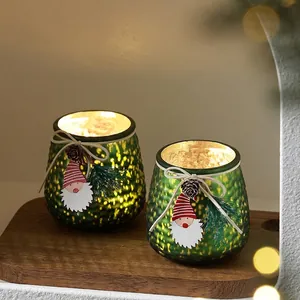 Green mercury glass Christmas candle holder set with pine cones and festive ornaments