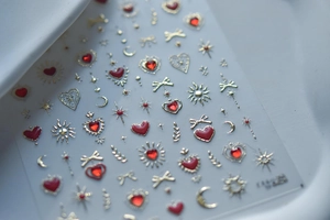Detailed view of gold and red nail stickers with star, moon, and butterfly designs
