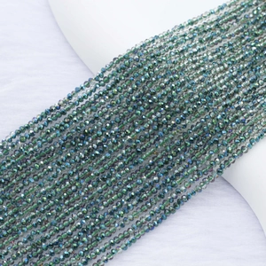 Macro shot of 2mm faceted crystal beads with metallic electroplated iridescent green finish