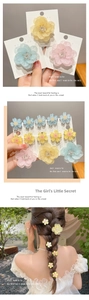Detailed close-up of pink cherry blossom hair clips with delicate pearls and floral petals