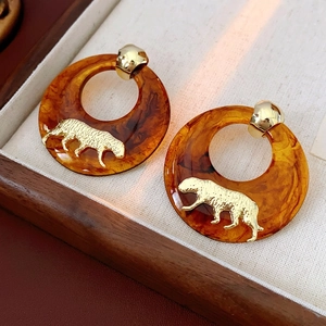 Amber resin hoop earrings with gold tiger relief shown in a luxury gift box